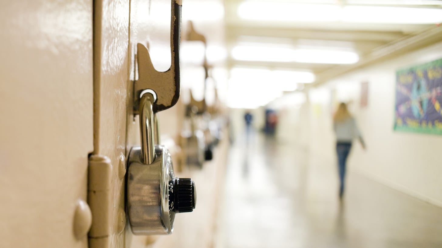 Close-up view of a padlock on a locker in a school hallway