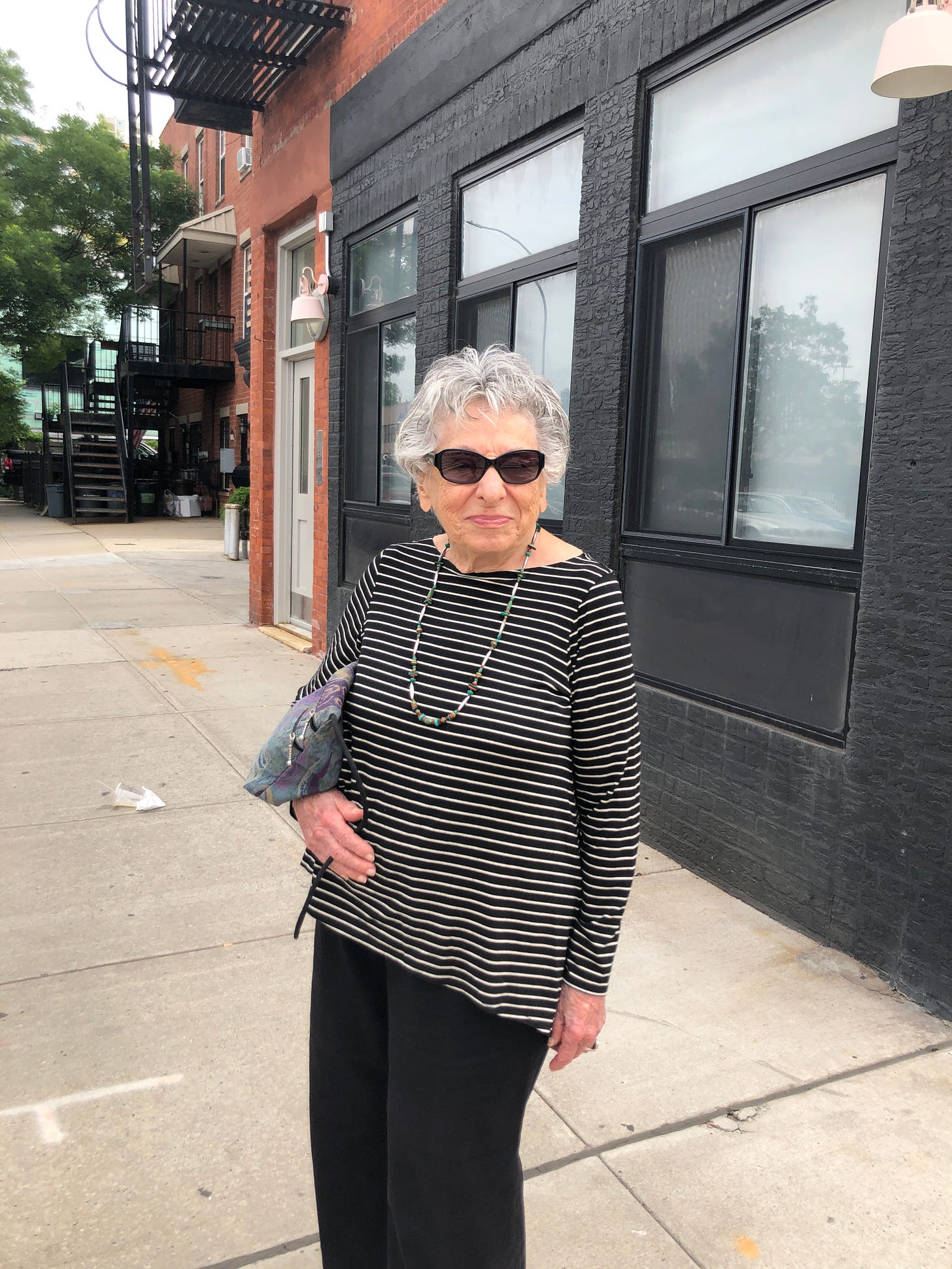 My grandma in sunglasses and a stripey shirt looking extremty cool on a street in Brooklyn.