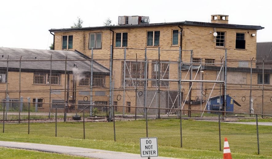 In this June 8, 2021, photo, a high fence surrounds buildings on the grounds of the Edna Mahan Correctional Facility for Women in Clinton, N.J. (AP Photo/Seth Wenig) **FILE**