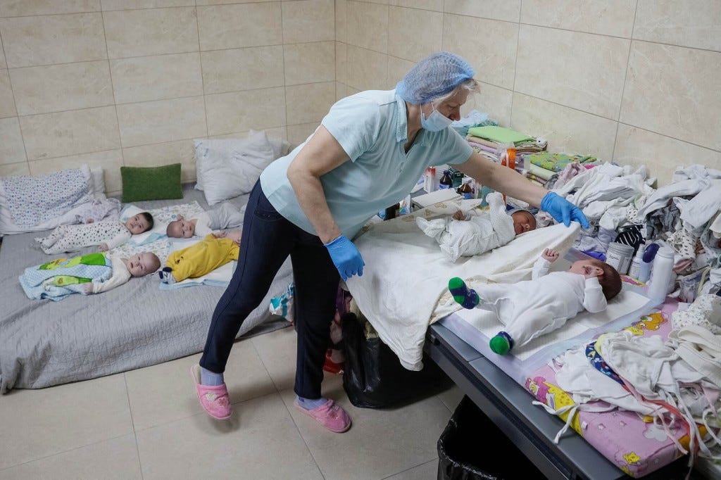 A nurse looks after surrogate-born babies inside a special shelter owned by BioTexCom clinic in a residential basement.