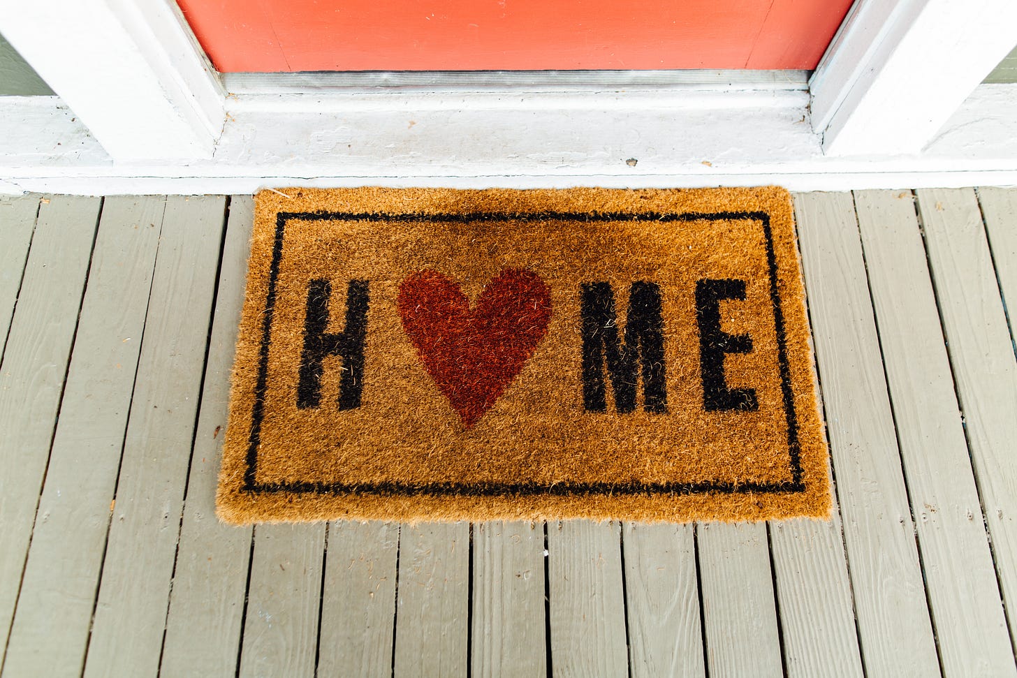 A rug by a front door that says Home