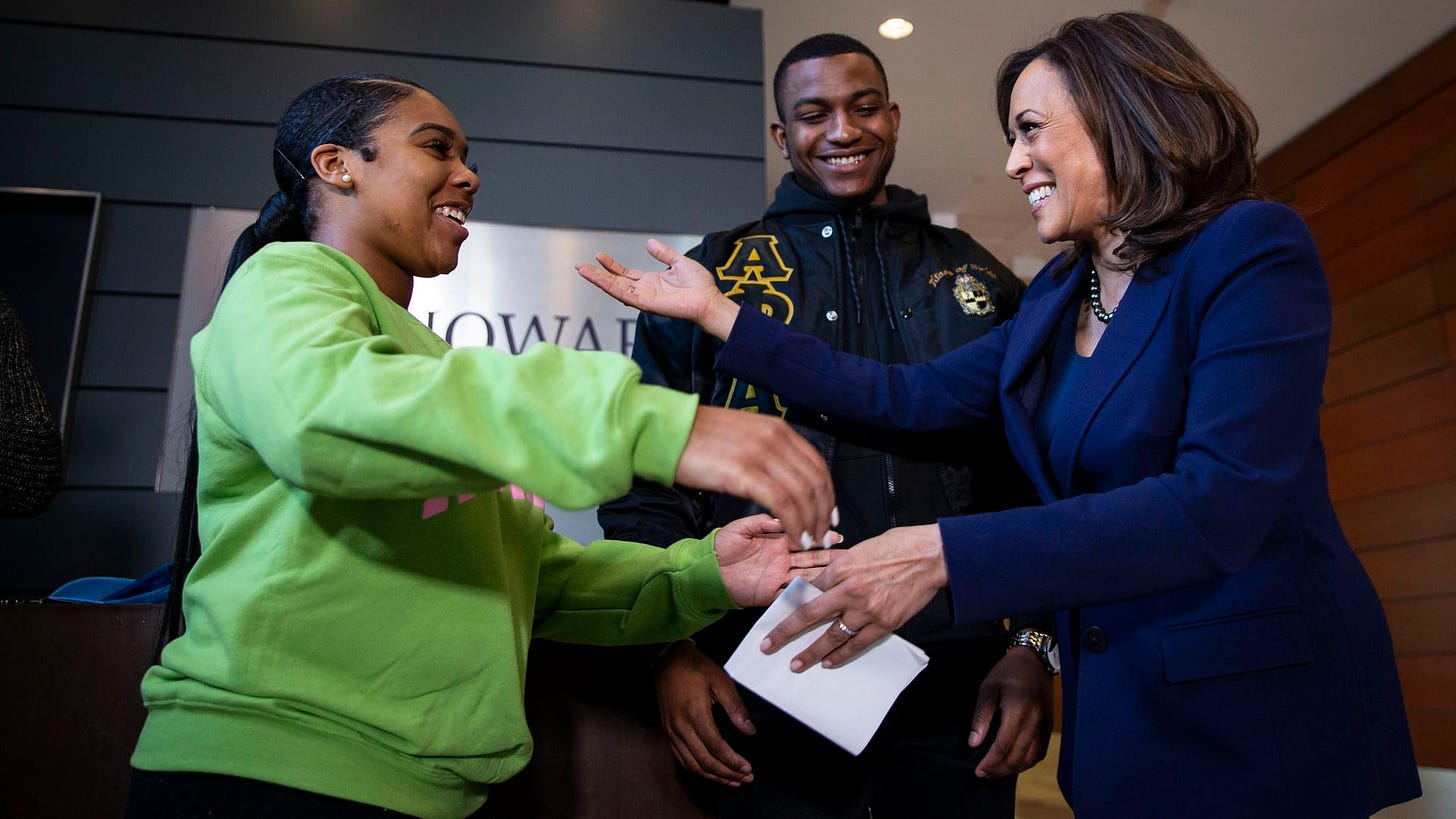U.S. Sen. Kamala Harris hugs Mara Peoples, Executive Vice President of the Howard University Student Association, beside Amos Jackson III, Executive President