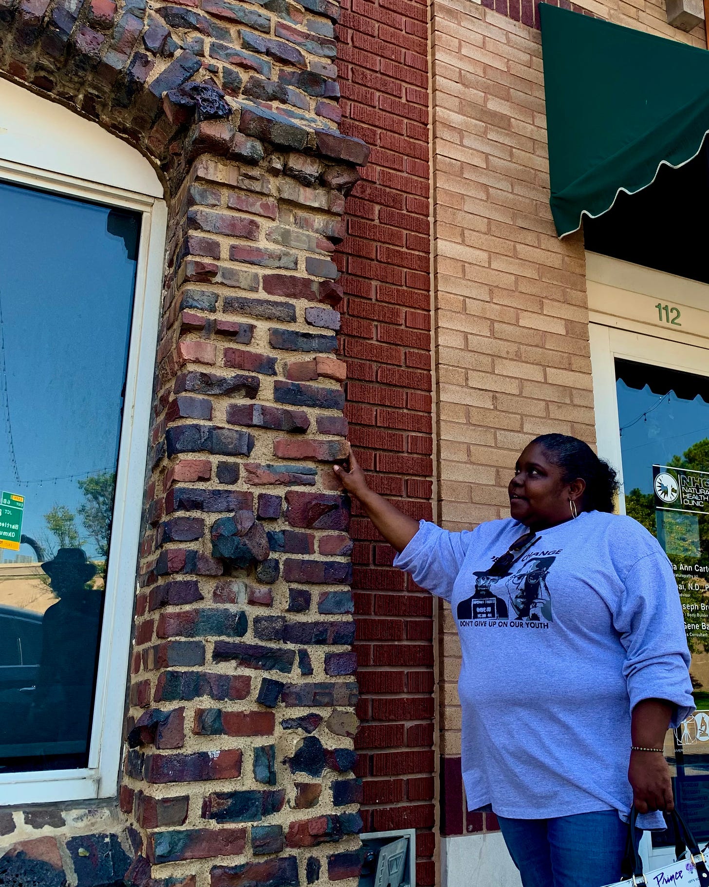 Kristi Williams with burnt brick facade