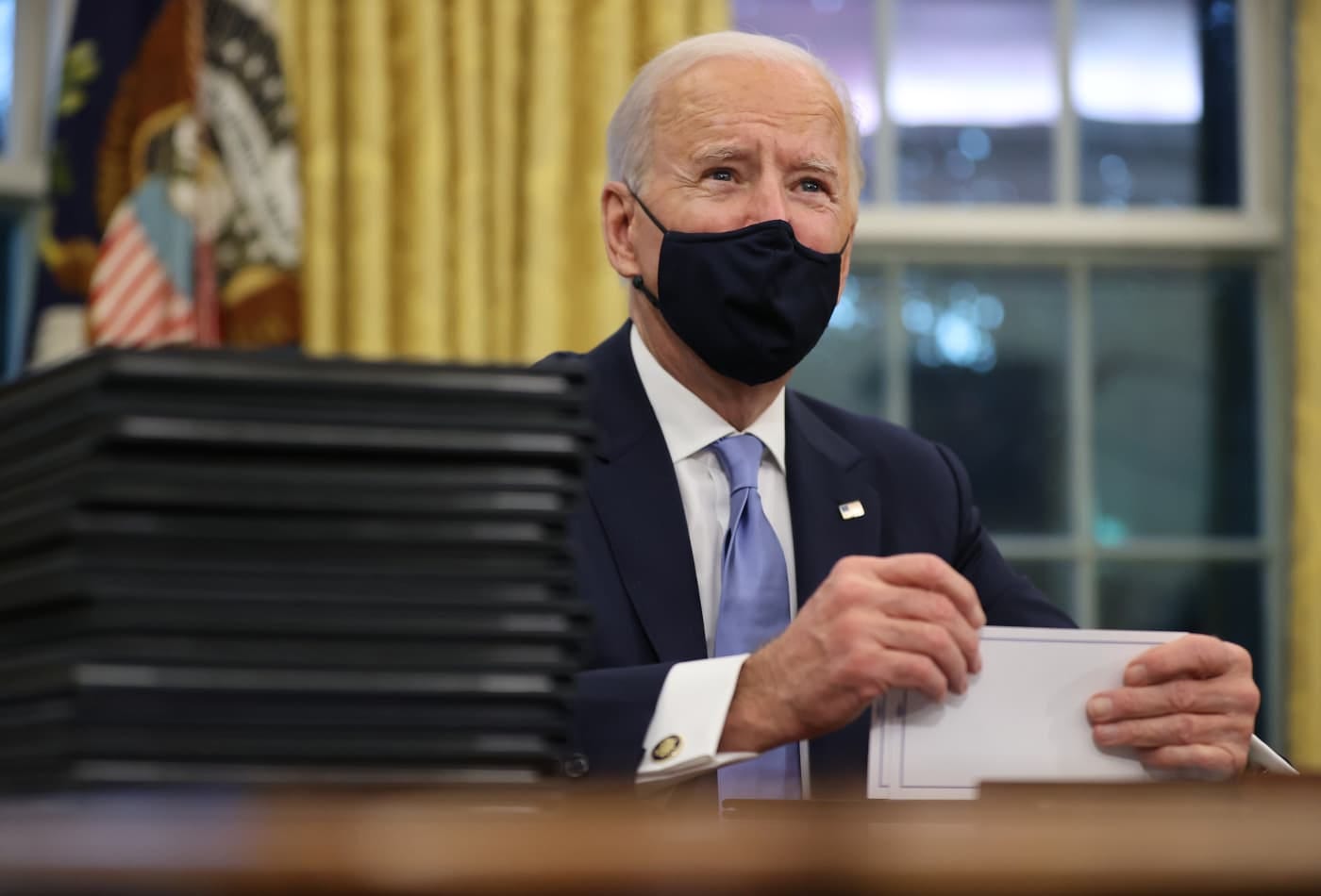 President Joe Biden prepares to sign a series of executive orders at the Resolute Desk in the Oval Office just hours after his inauguration on January 20, 2021 in Washington.