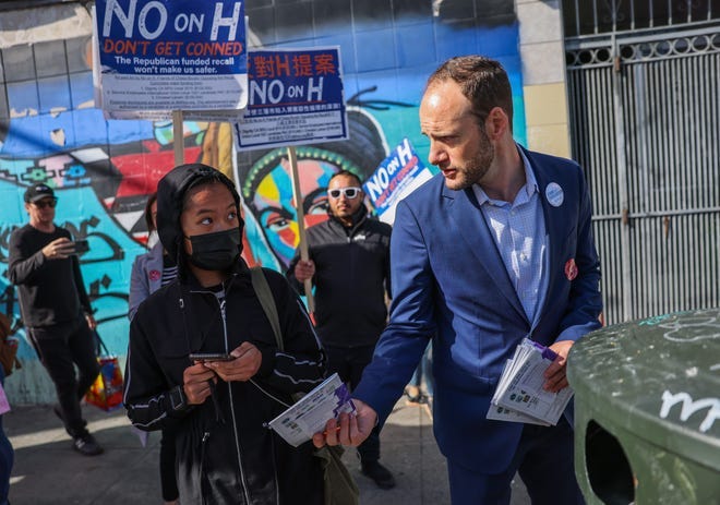 District Attorney Chesa Boudin hands out fliers in the Mission ahead of the recall on Tuesday, June 7, 2022, in San Francisco.