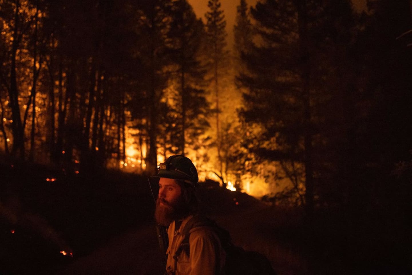 A firefighter with the Tallac Hotshots, fighting the Dixie Fire, made sure a controlled burn did not leave the lines of containment in Genesee, Calif. early Friday. Many of the biggest blazes around California were still much less than 50 percent contained as of Friday morning.