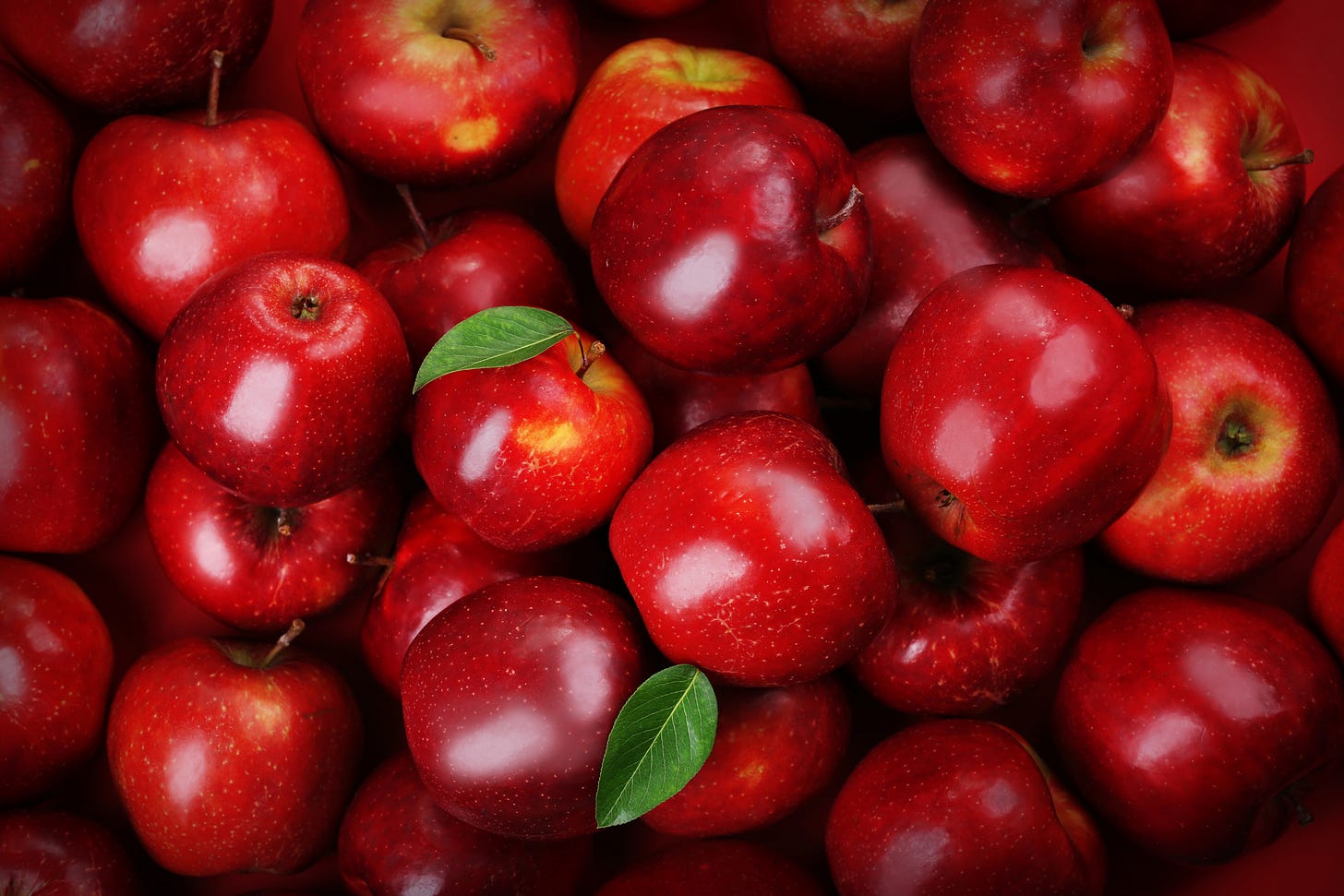 red delicious apples piled on top of each other