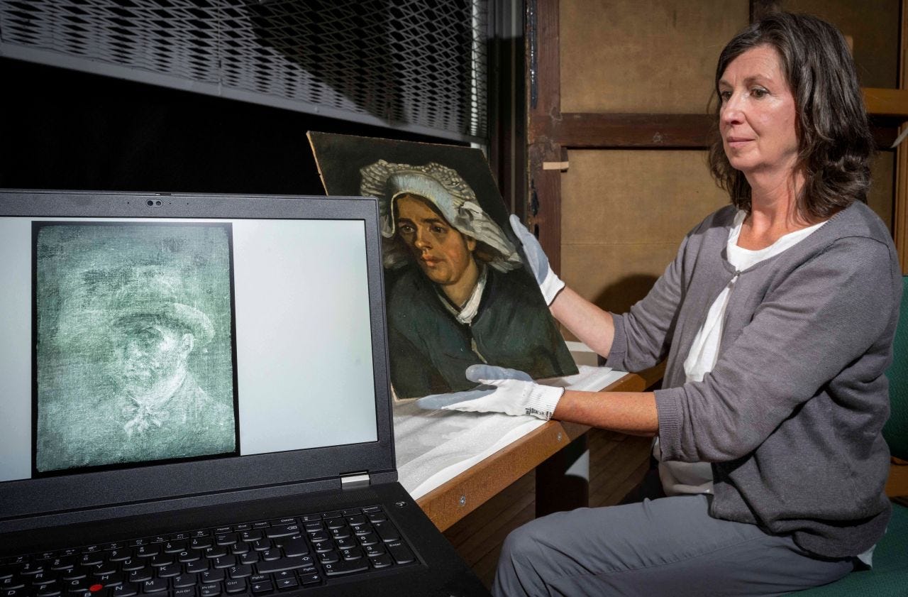 A woman sits on the right side of the frame holding up the original painting, "Head of a Peasant Woman," in gloved hands. In the foreground is a laptop opened with an image of the Van Gogh self-portrait x-ray conveyed in shades of blue-gray and white.