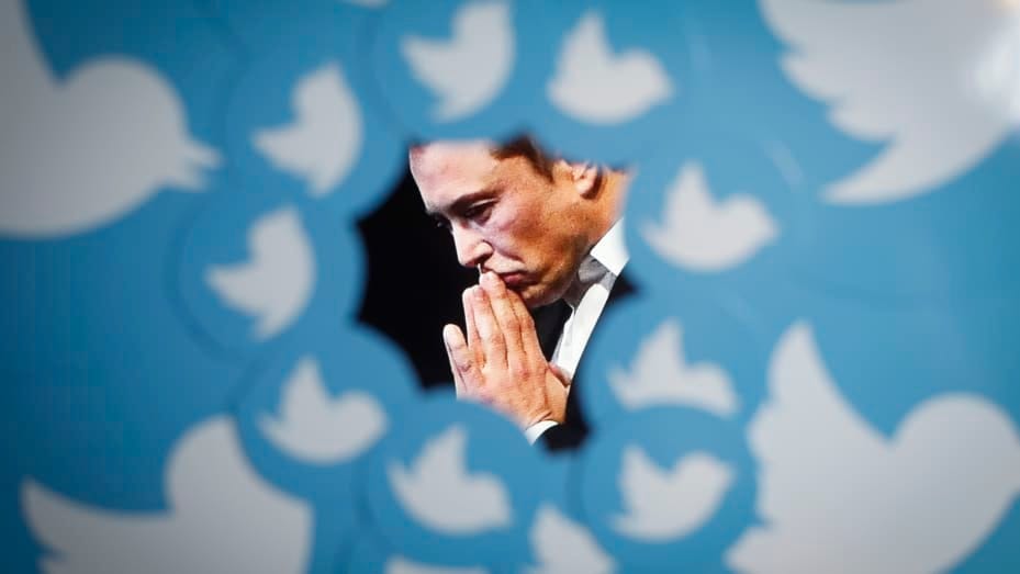 An image of new Twitter owner Elon Musk is seen surrounded by Twitter logos in this photo illustration in Warsaw, Poland on 08 November, 2022. (Photo by STR/NurPhoto via Getty Images)