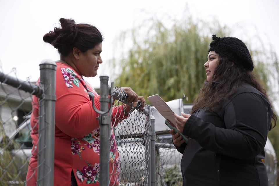District 1 City Council candidate Eliana Macias, 28, speaks with a resident, Elizabeth Hererra, while canvassing in Yakima.