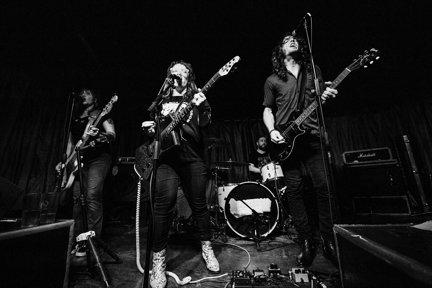 black and white photo of two guitarists, a bassist and a drummer