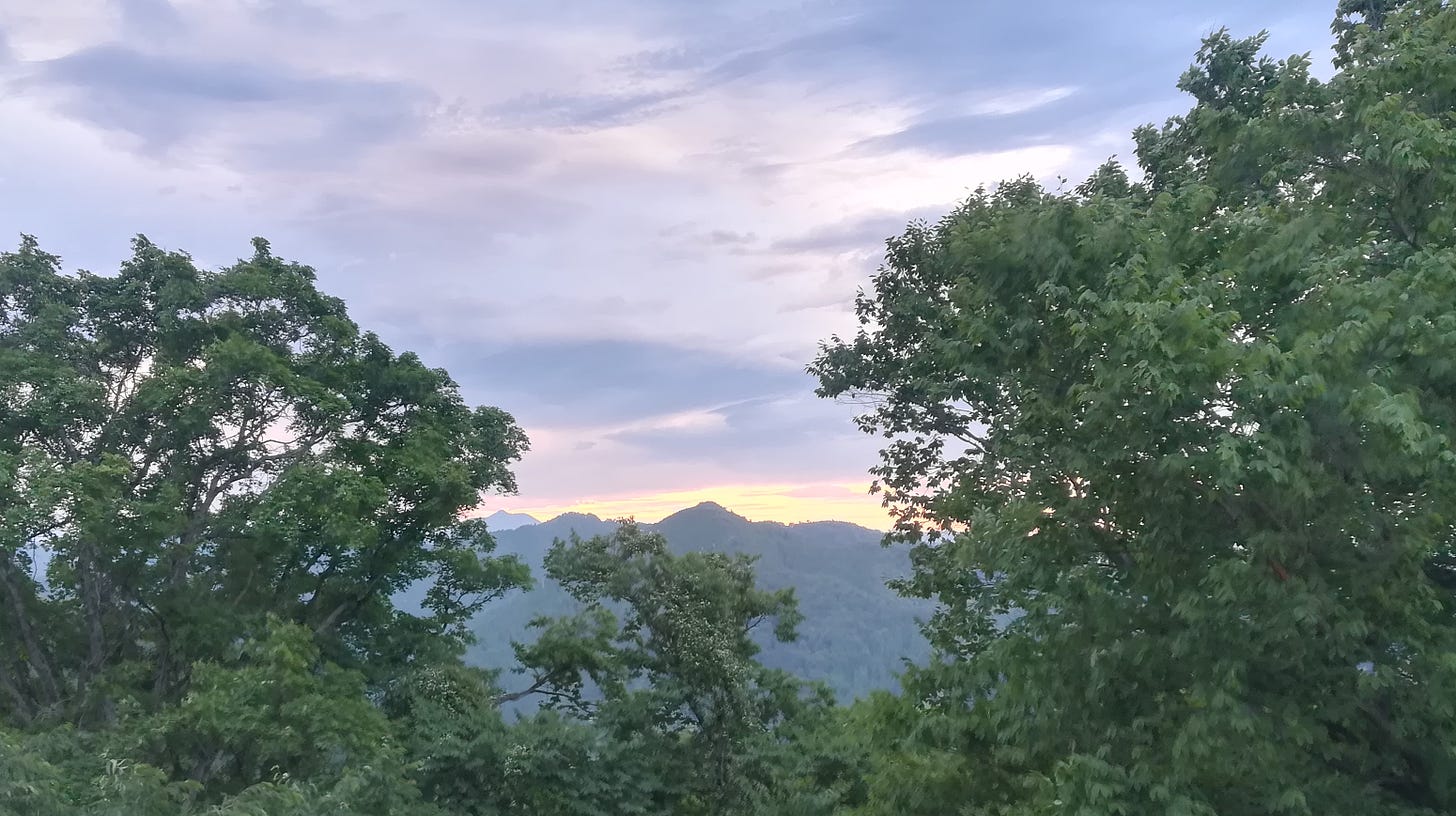 photo of a sunset behind a mountain