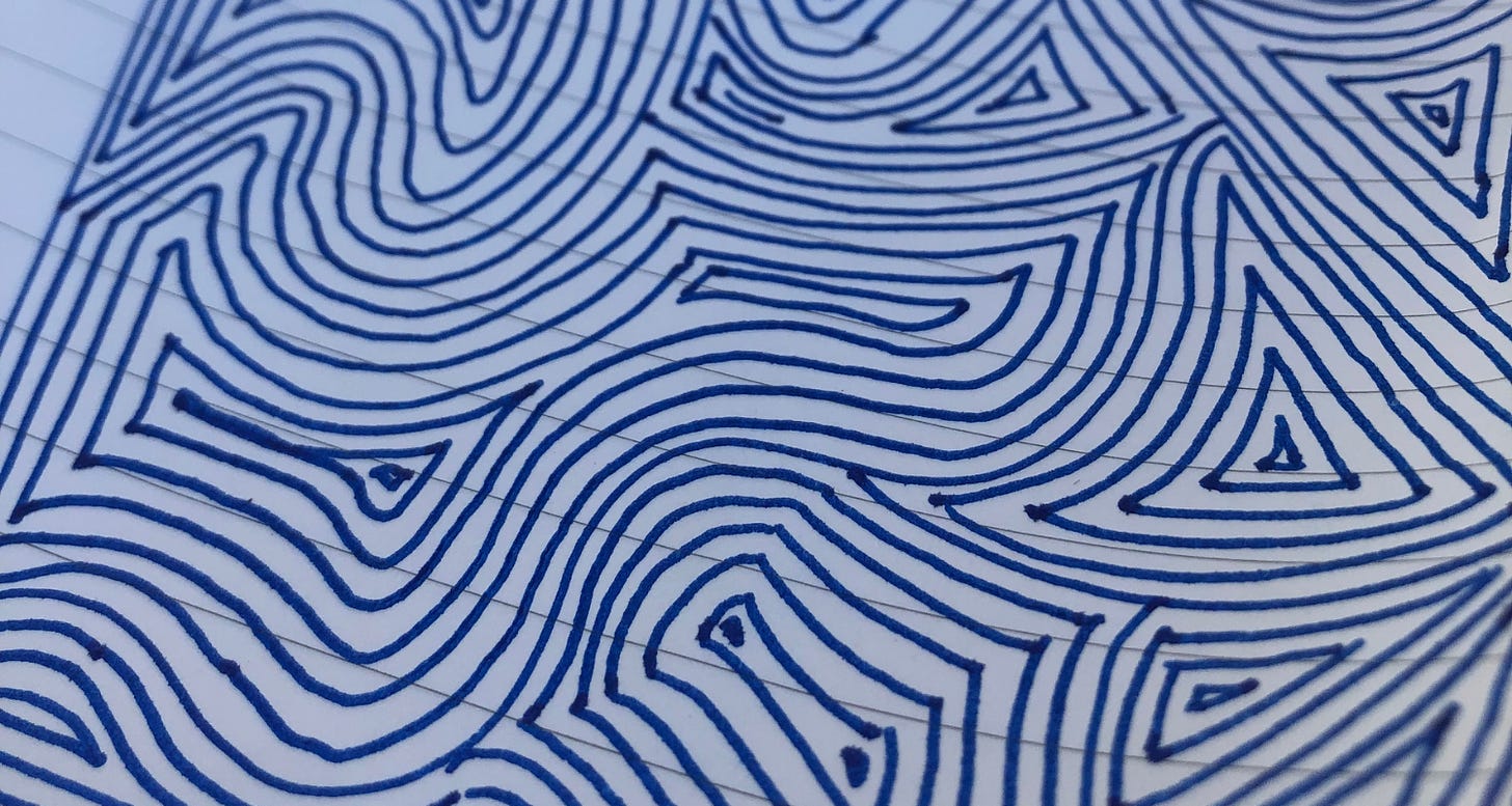 A freeform doodle on lined paper, drawn in blue ink