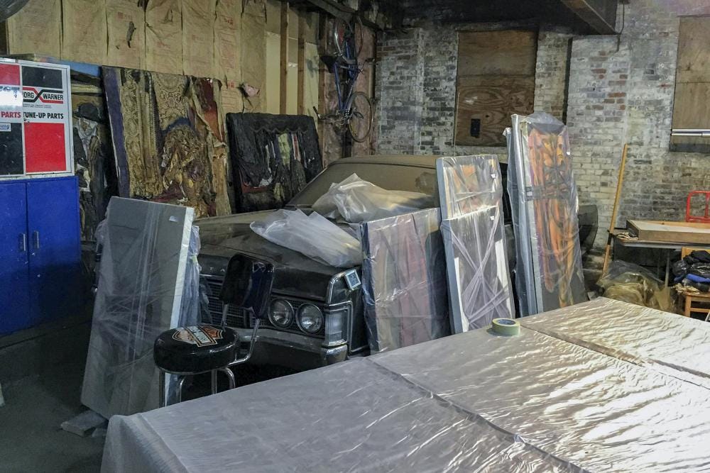 Paintings by Francis Hines sit wrapped in plastic in a barn Sept. 27, 2017, in Watertown, Conn. After fading into obscurity, Hines, who died in 2016, is again gaining attention after hundreds of his paintings were rescued by a car mechanic from a dumpster in Connecticut. An exhibit of that art will open May 5, 2022, at the Hollis Taggart galley in Southport, which is known for showing the works of lost or forgotten artists. (Jared Whipple via AP)