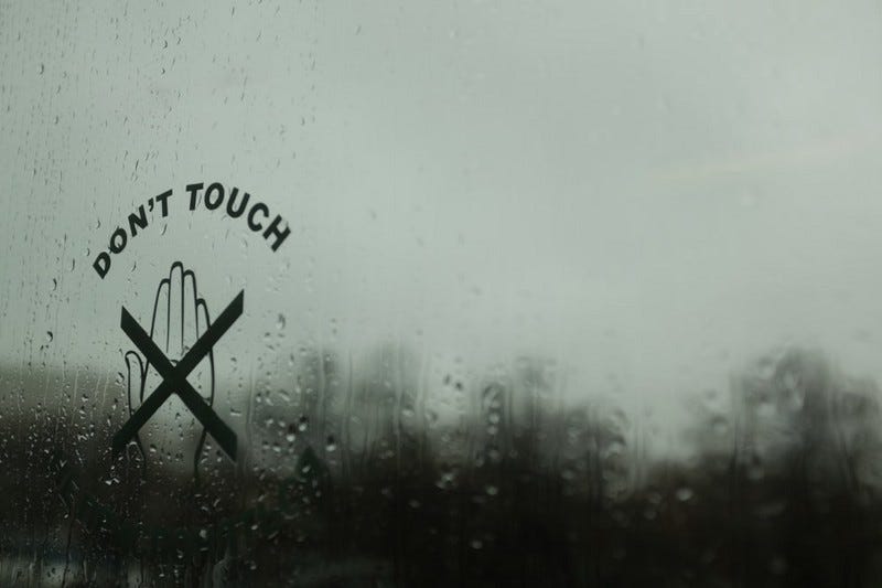 Picture of a rainy window with a crossed-out hand and text “Don’t touch”