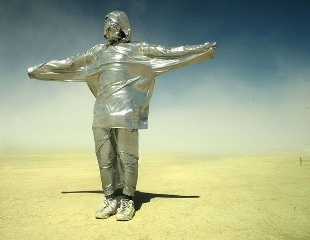 A man wrapped in duct tape stands during a sandstorm at the Burning Man Festival back in 2003