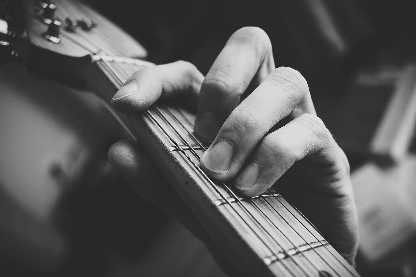 Image of a man practising guitar for article titled “Practice Intensely, Show up, Then See What Happens” by Larry G. Maguire