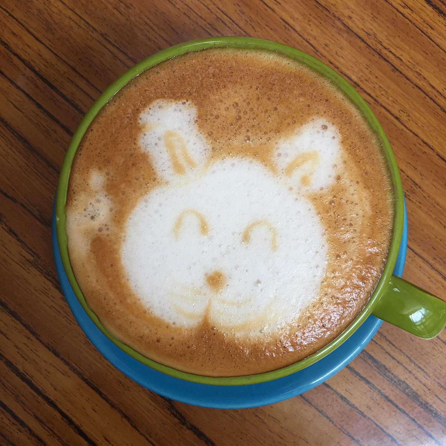 latte with animal face foam (cat? bear?)
