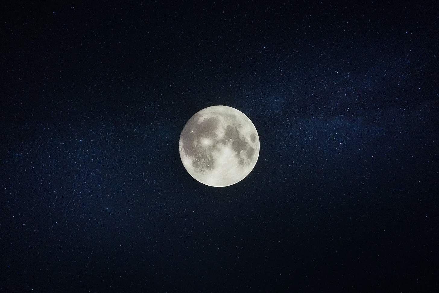 The moon is front and centre with a bed of stars behind it