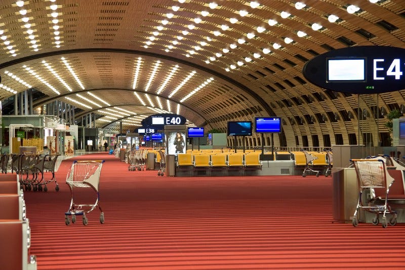 empty airport showing seats and trolleys