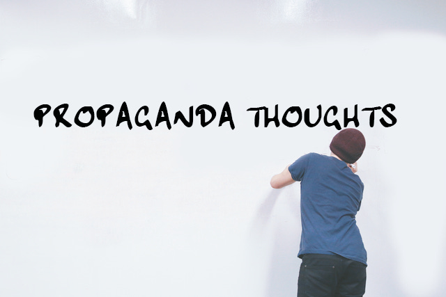 Picture of man writing Propoganda Thoghts on a large whiteboard