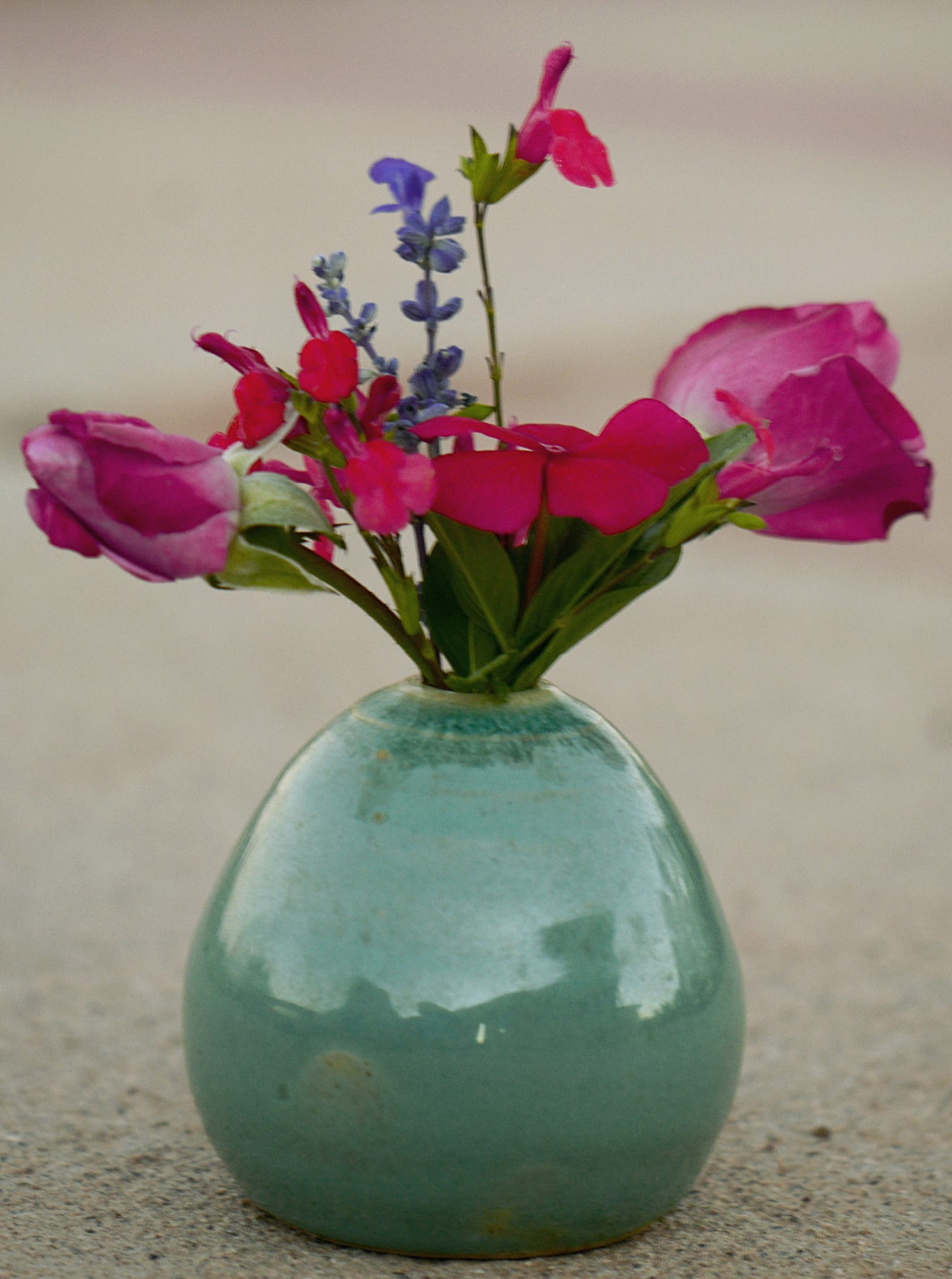 small vase with vinca, salvia and rosebuds