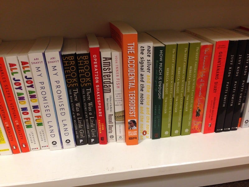 Photograph of a bookshelf in a bookstore, featuring non-fiction books alphabetized by author from Charles Seife through Patti Smith and including The Accidental Terrorist by William Shunn.