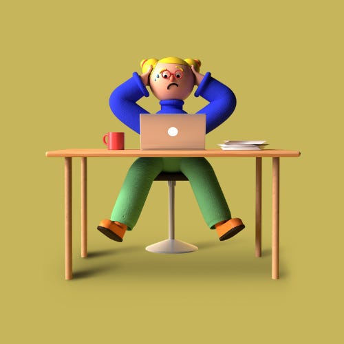 A person sat at a desk that has a red mug, a laptop, and notebooks on it. The person is sat with their hands raised to their head with a worried look on their face.