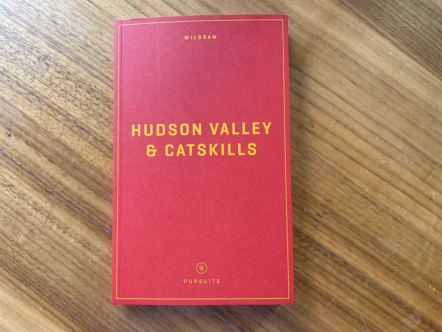 Photo of Wilsdam Hudson Valley & Catskills, a red guide with yellow lettering, on a wooden table