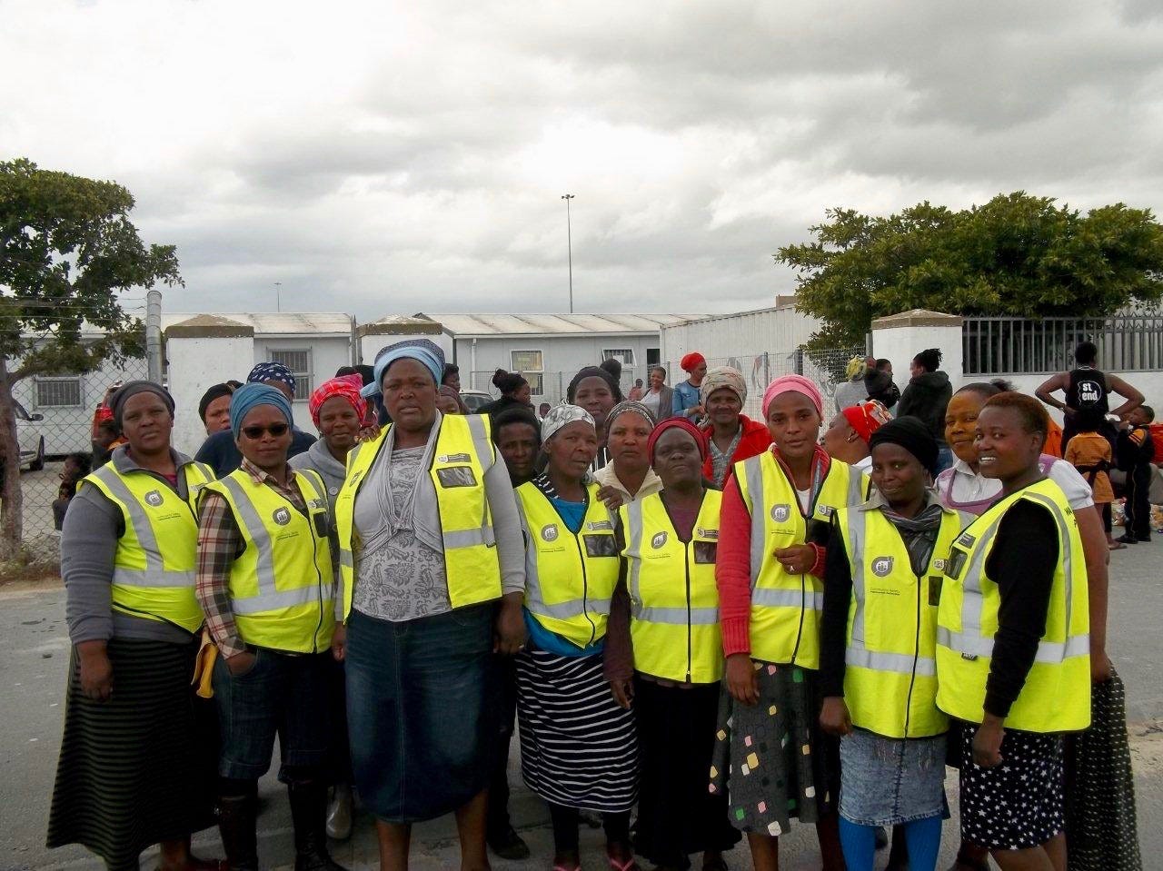 a group of people in a walking bus in high vis jackets