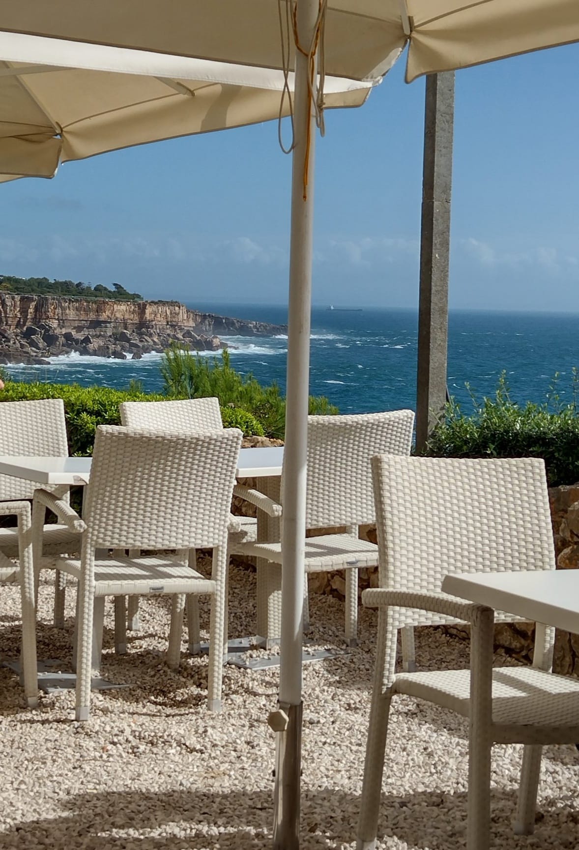 Tables and chairs by the ocean