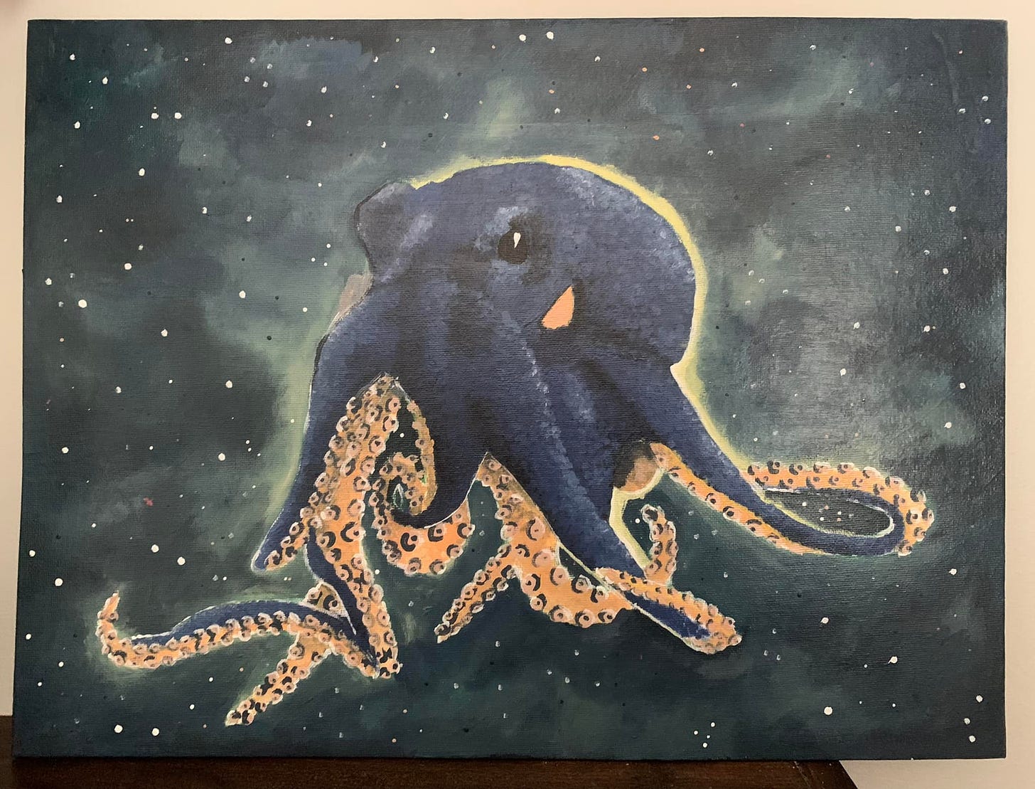 Acrylic painting of a dark blue octopus in outer space.