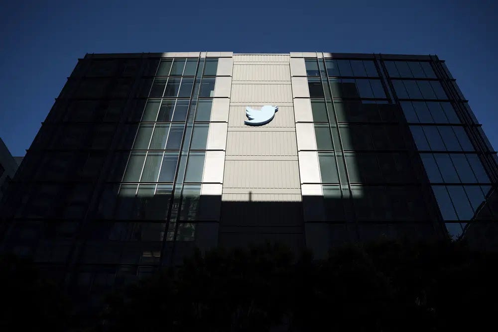 FILE - A Twitter logo hangs outside the company's San Francisco offices on Tuesday, Nov. 1, 2022. The Washington Post’s Taylor Lorenz has become the latest journalist to be banned from Twitter. Lorenz says she and another Post technology reporter, Drew Harwell, were researching an article concerning Twitter CEO Elon Musk. (AP Photo/Noah Berger, File)