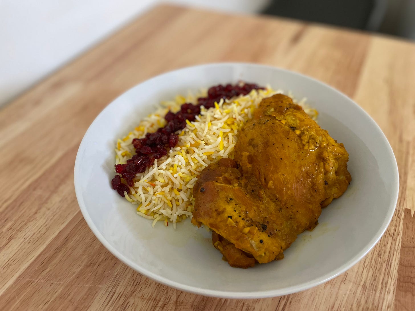 Saffron chicken thigh served with basmati rice and barberries