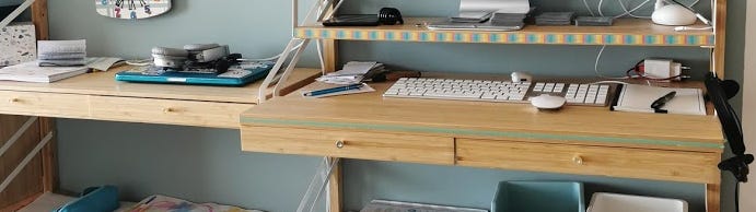 Official Svalnas workstation with drawers drawn out and hidden under a shelf, which extends the surface. 