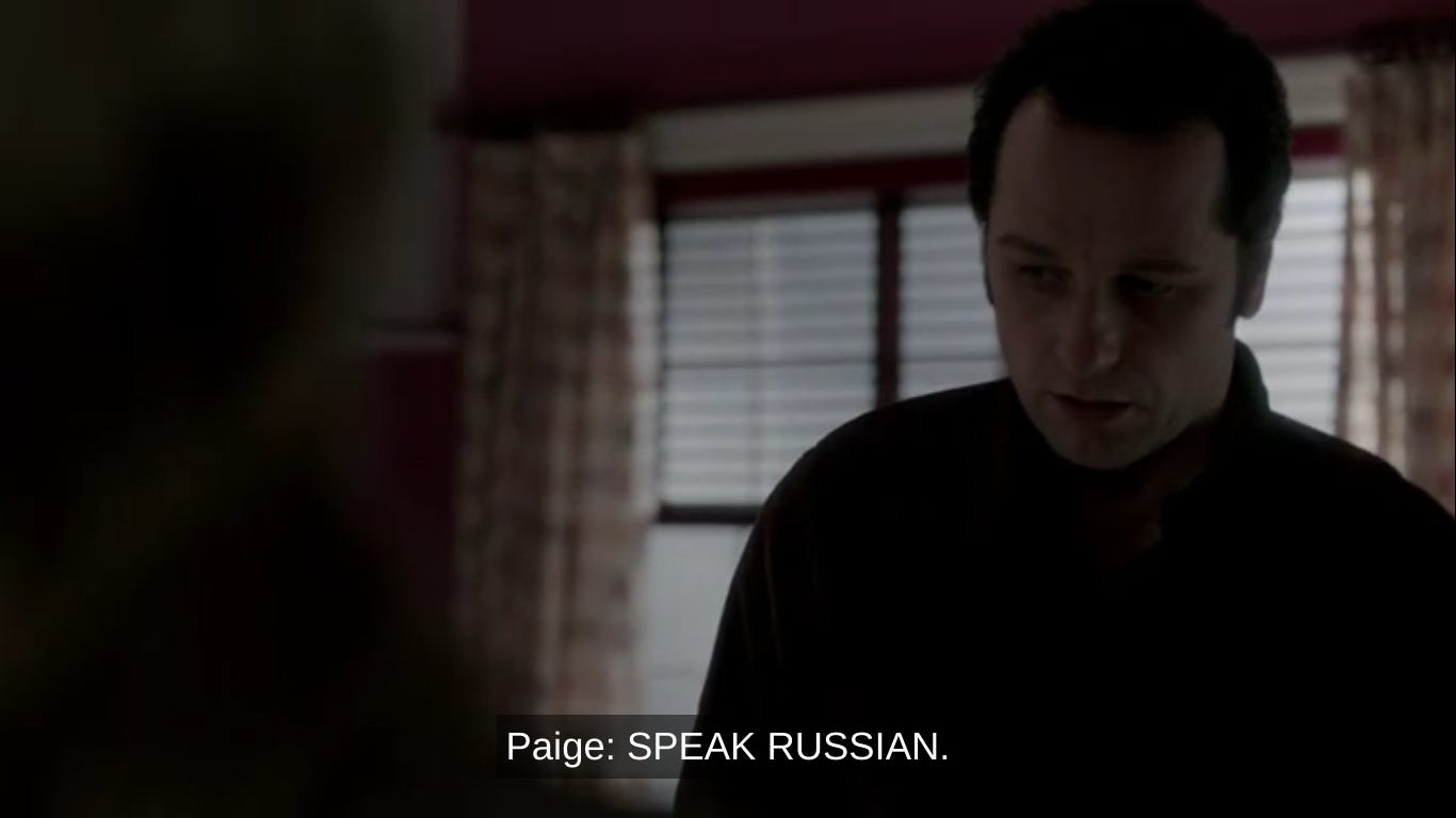 Camera is on Philip while the caption shows Paige saying "Speak Russian"