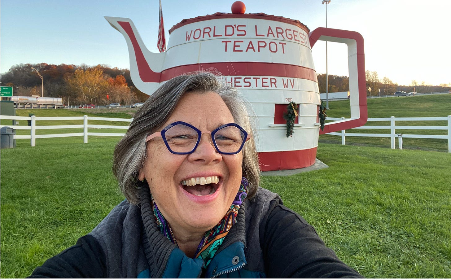Tamela standing in front of the world's largest teapot in Chester, West Virginia
