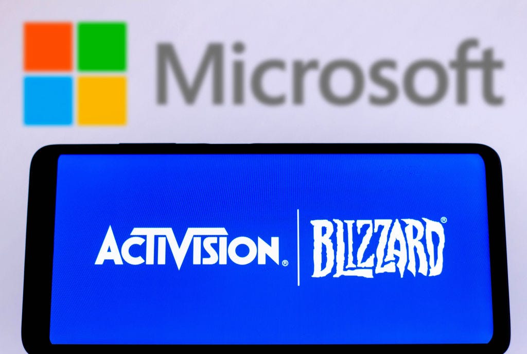 Photo illustration of Microsoft logo above Activision logo showing on a smartphone. Rafael Henrique / Getty Images