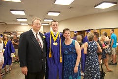 Andrew with mom and dad at graduation