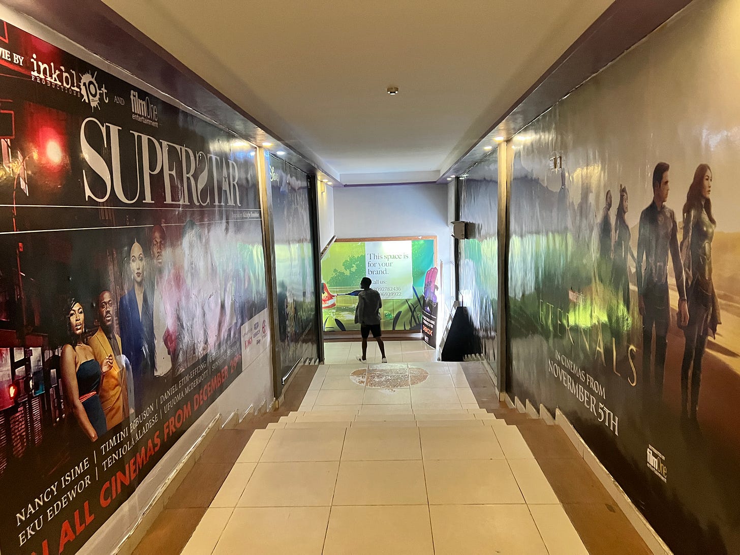A walkway in the Filmhouse Surulere cinema with movie posters