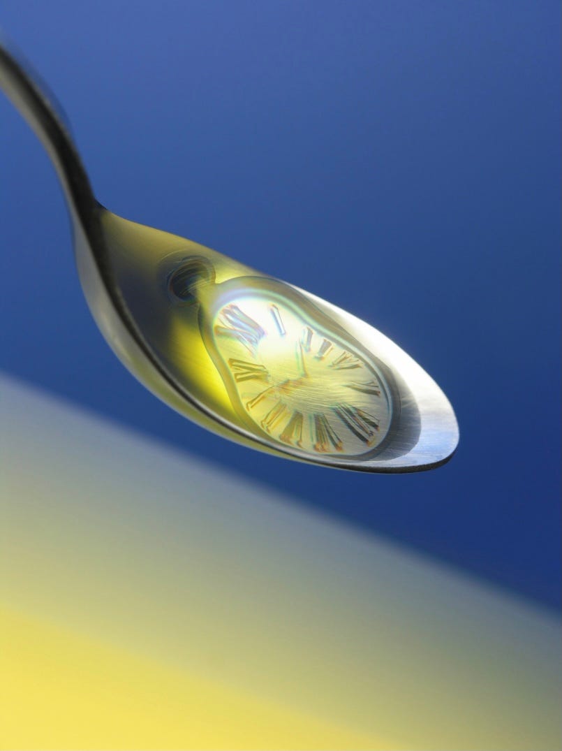 Spoon filled with oil and melting clock