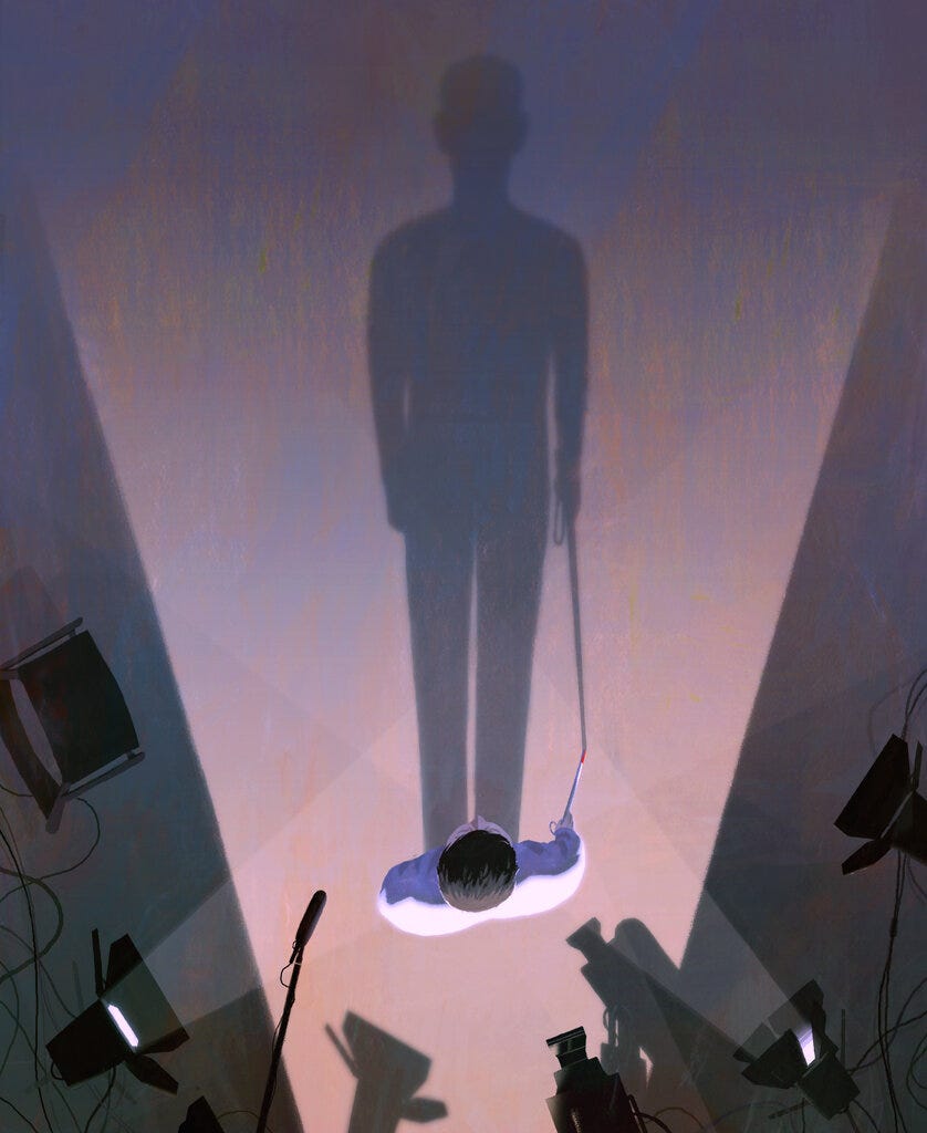 Illustration of a man holding a white cane with a red tip standing on a TV set whose lights project his long shadow across the floor. Illustration by Dadu Shin
