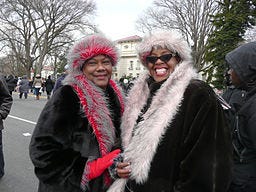 Two happy looking women in coats and hats