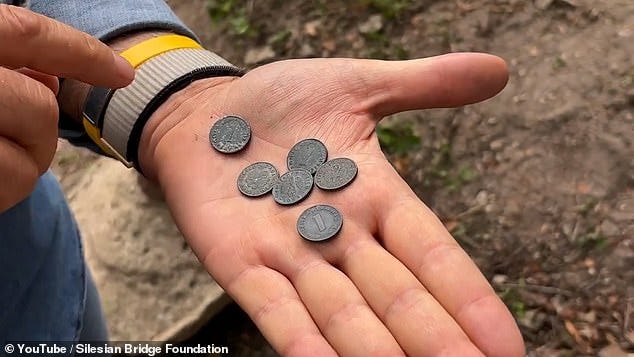 Bart Zelaytys shows the six coins found in Minkowskie in the palm of his hand