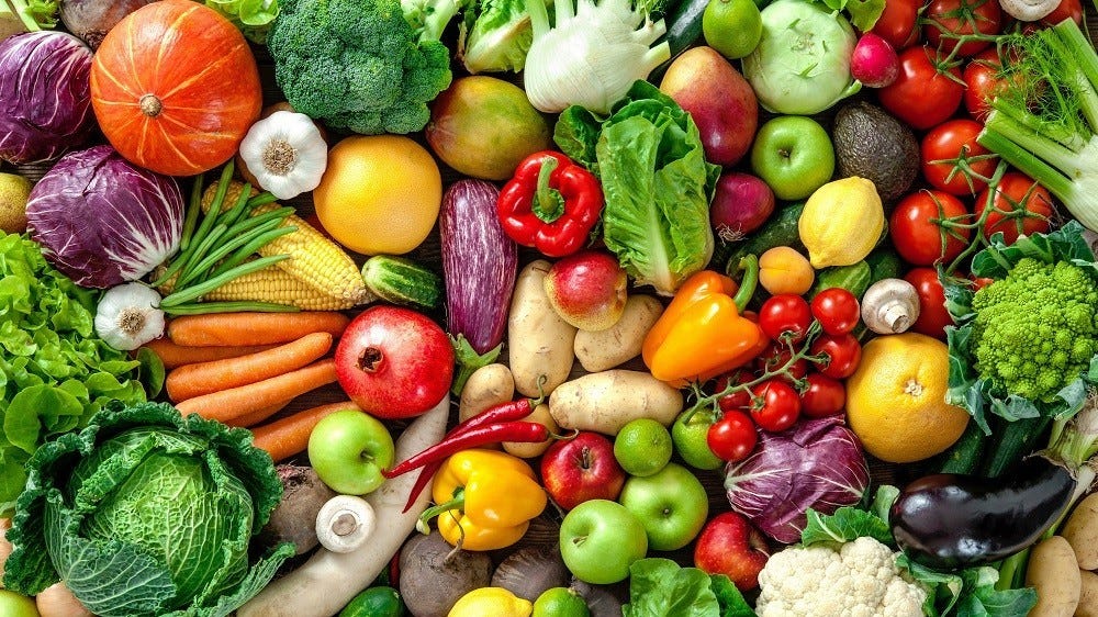 An assortment of colorful vegetables and fruits on a flat surface