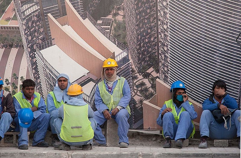 File:Migrant workers in West Bay Doha.jpg