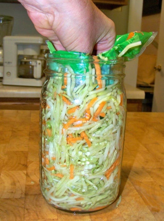 Press Slaw Down Until 1" of Headroom is Left in Jar for Fermented Broccoli Kraut