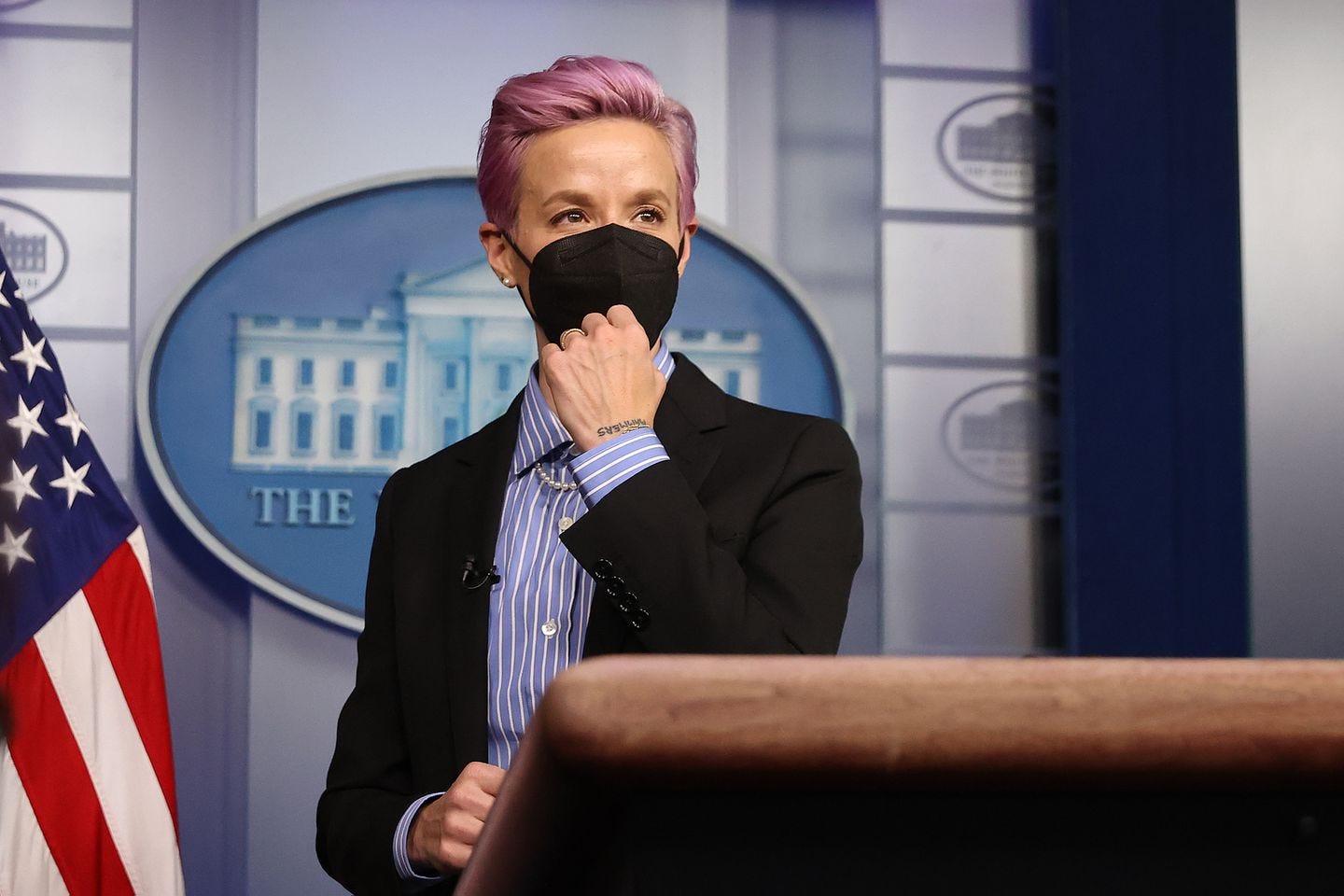 Professional soccer player Megan Rapinoe stood at the podium of the Brady Press Briefing Room before meeting with President Biden to raise awareness of pay disparity issues.