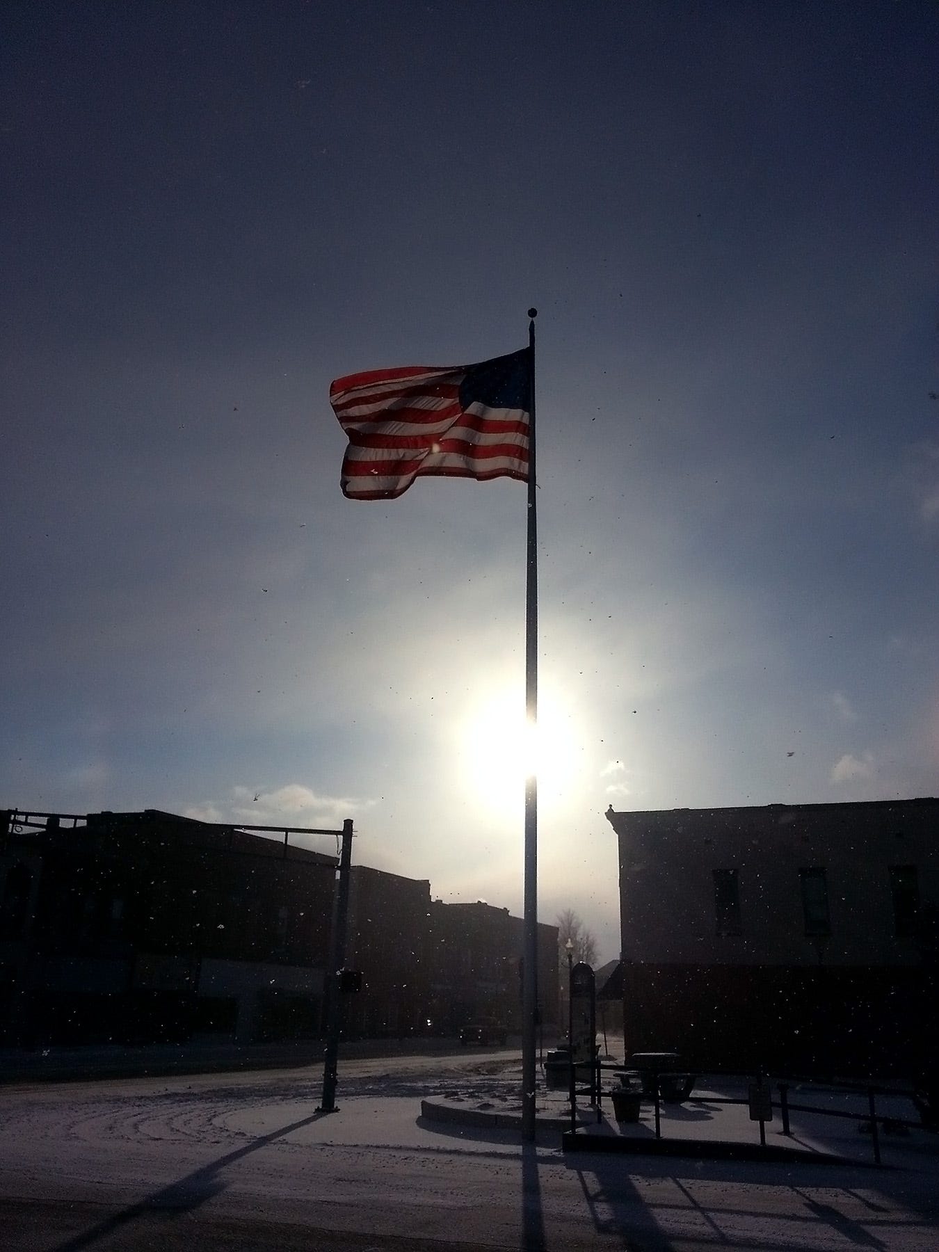 The deep cold of winter creates crisp, clear conditions on Knightstown’s Public Square, located just of U.S. 40. A late afternoon sun illuminates snow flurries and Old Glory, whipping angrily in a brisk, southwesterly wind. 