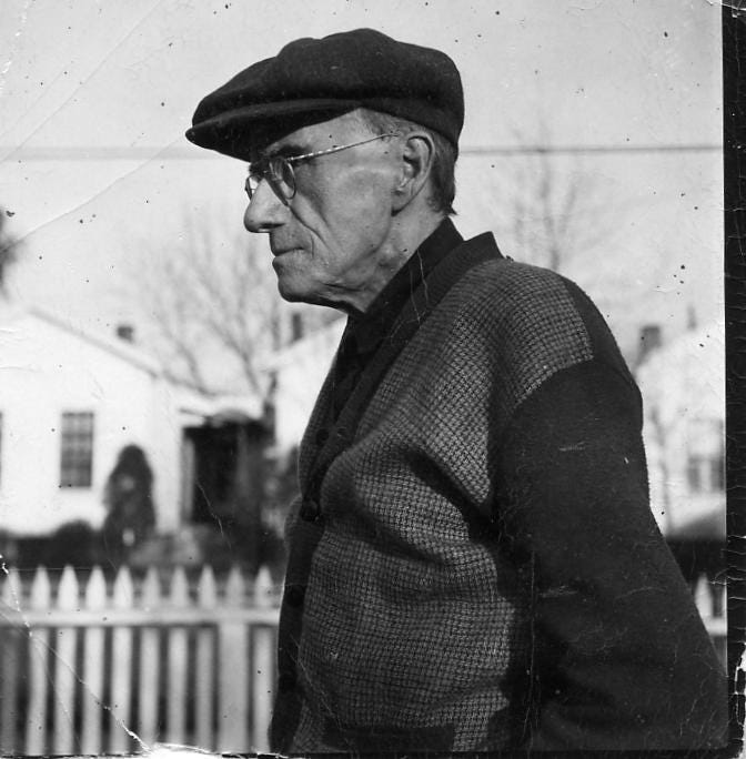 old man in cap and sweater, picket fence